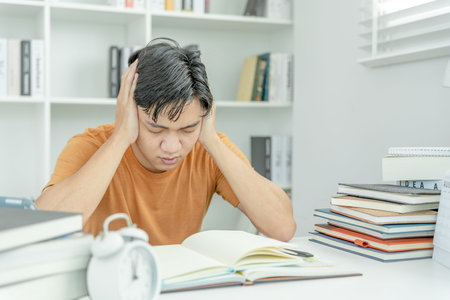 Asian student man have anxiety because of exams, male prepare for test and learning lessons in the...