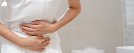 Constipation and diarrhea in bathroom. Hurt woman touch belly  stomach ache painful. colon inflammation problem, toxic food, abdominal pain, abdomen, constipated in toilet, stomachache, Hygieneの写真素材