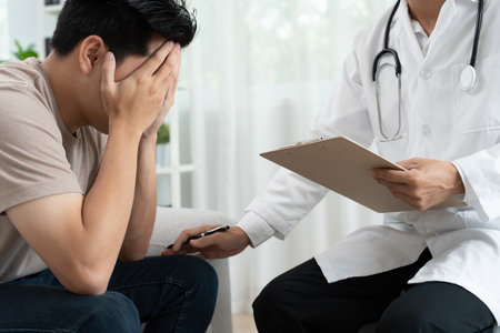 man with mental health problems is consulting. psychiatrist is recording the patient's condition for treatment.の写真素材