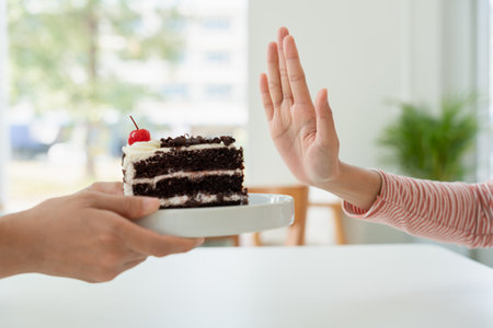 female healthy confuse chocolate cake. Woman in restaurant achieves weight loss goal for healthy life, crazy about thinness, thin waist, nutritionist. Diet, body shape.の写真素材