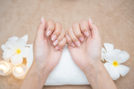 Woman show beautiful nail after receive care service by professional Beautician Manicure at spa centre. Nail beauty salon use nail file for Glazing treatment. manicurist make nail to beautiful.の写真素材