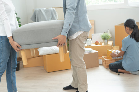 Moving house, relocation. Couple choose design for building new apartment, inside the room was a cardboard box contain personal belongings and furniture. move in the new apartment or condominiumの写真素材