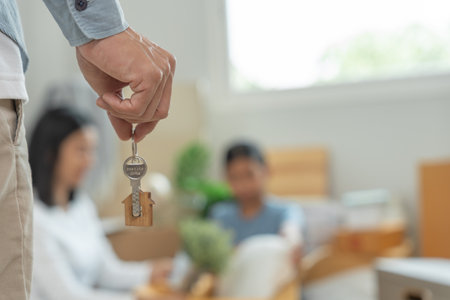 Moving house, relocation. Man hold key house keychain in new apartment. move in new home. Buy or rent real estate. flat tenancy, leasehold property, new landlord, investment, dwelling, loan, mortgage.の写真素材