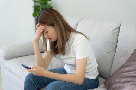 Unhappy asian woman girl disappointed, sad about problem in home alone, feel lonely, Stressed, suffering from bad relationship, break up, divorce, female confused, depression mental health, lonelinessの写真素材