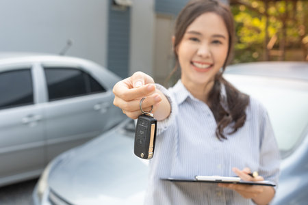 lease, rental car, sell, buy. Dealership manager send car keys to the new owner.  Sales, loan credit financial, rent vehicle, insurance,  renting, Seller, dealer, installment, car care businessの写真素材
