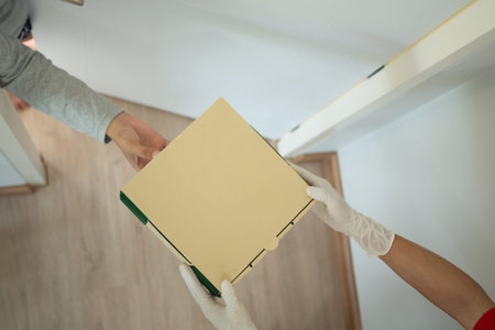 woman receives boxes parcel from courier in front house. Delivery man send deliver express. online...