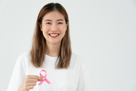 Woman hold pink ribbon breast cancer awareness. Female health check consciousness. international Women Day and World Cancer Day. sign cancer, Symbolic, health care, support patients, timely diagnosisの写真素材