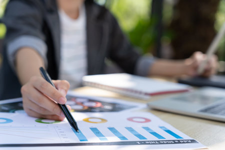 Business women calculate benefit, spreadsheets, graph financial development, bank accounts, statistics, economy, data analysis, investment analysis, stock exchange,Interest rates, incomeの写真素材