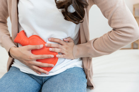 stomach ache. Asian women have abdominal pain, indigestion, gastritis, menstrual cramps, flatulence, diarrhea, distention, colon cancer, belly inflammation problem, suffer food poisoning, abdomenの写真素材
