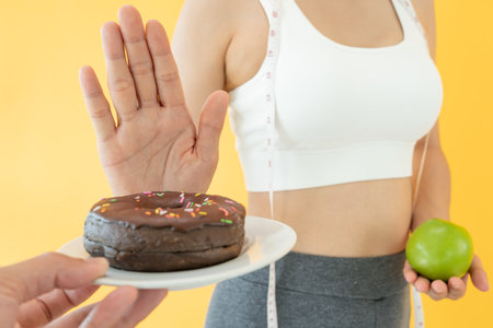 Beauty slim female body confuse chocolate cake. Woman in restaurant achieves weight loss goal for healthy life, crazy about thinness, thin waist, nutritionist. Diet, body shape.の写真素材