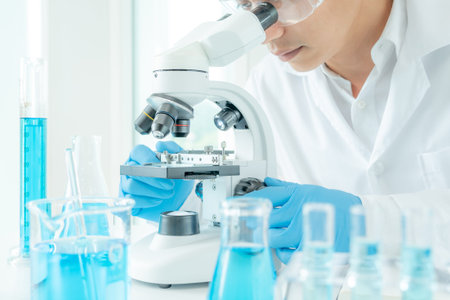Scientist analyze biochemical samples in advanced scientific laboratory. Medical professional use...