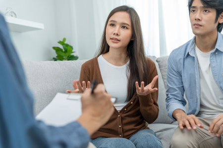 Couple support each while discussing family issues with psychiatrist. Husband encourages and empathy wife suffers depression. psychological, divorce, trust, care, workplace and health issues.の写真素材