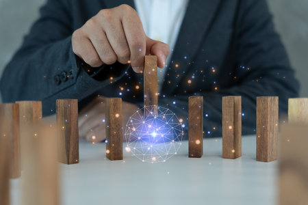 insurance with hands protect domino. Businessman hands stop dominoes falling in business crisis. business risk control and planning and strategies to run prevent insurance businessesの写真素材