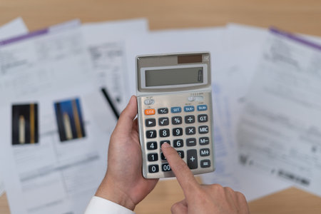 Stressed and headache man with large bills or invoices no money to pay to expenses and credit card debt. shortage, Financial problem, bankruptcy, mortgage, loan, bankrupt, poor, empty walletの写真素材