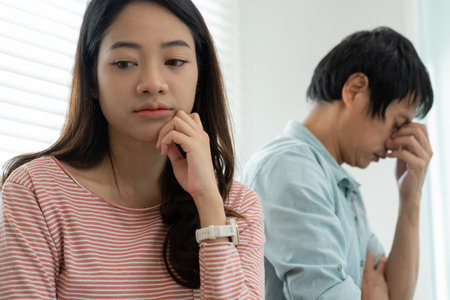 Divorce. Asian couples are desperate and disappointed after marriage. Husband and wife are sad, upset and frustrated after quarrels. distrust, love problems, betrayals. family problem, teenage loveの写真素材