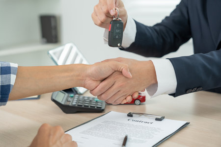 lease, rental car, sell, buy. Dealership manager send car keys to the new owner.  Sales, loan credit financial, rent vehicle, insurance,  renting, Seller, dealer, installment, car care businessの写真素材