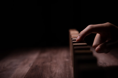 insurance with hands protect domino. Businessman hands stop dominoes falling in business crisis. business risk control and planning and strategies to run prevent insurance businesses.の写真素材