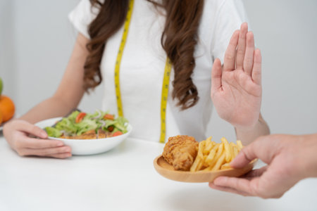 Beauty slim female body confuse fat food. Woman in restaurant achieves weight loss goal for healthy life, low calorie, thin waist, nutritionist. Diet, body shape, balance control, avoid, nutritionalの写真素材