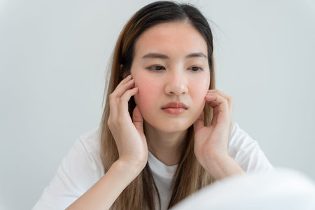 Stressed and headache asian woman with large bills or invoices no money to pay to expenses and...