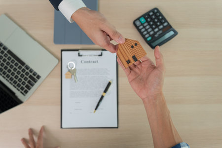 lease, rental and selling home. Real estate agent manager smile holding key for new owner.  rent house, Sales, loan credit financial, insurance, Seller, dealer, installment,  buy, sell, move inの写真素材