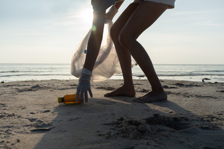 Save water. Volunteer pick up trash garbage at the beach and plastic bottles are difficult decompose prevent harm aquatic life. Earth, Environment, Greening planet, reduce global warming, Save worldの写真素材