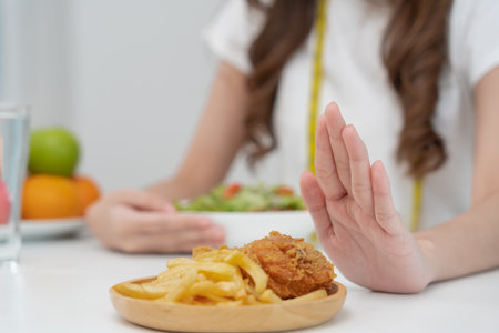 Beauty slim female body confuse fat food. Woman in restaurant achieves weight loss goal for healthy life, low calorie, thin waist, nutritionist. Diet, body shape, balance control, avoid, nutritionalの写真素材