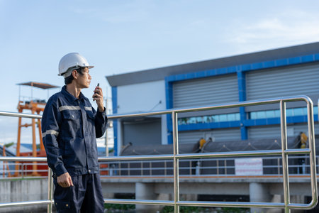 maintenance and inspector. Maintenance engineers are using walky talky to inform the results of inspection of buildings and structures. Irrigation engineers are exploring sluice systemsの写真素材