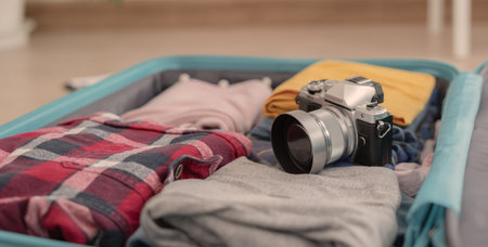 Traveler. preparing a camera for travel and photography. women are prepare clothes and personal...