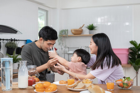 daughter is kissing her father's cheek. activities together during the holidays. Parents and children are having activity on vacant time. weekend, enjoyment, happy family, togetherness, feel good.の写真素材