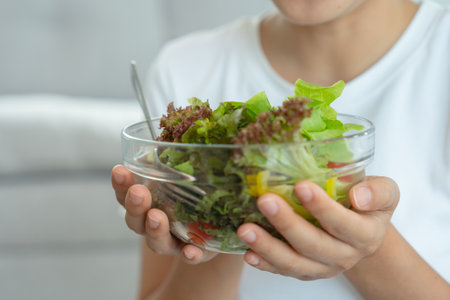 Diet and dieting, enjoy eat. Healthy woman hold salad food and feeling happy. Beauty slim female body achieves weight loss goal for healthy life, crazy about thinness, thin waist, nutritionist.の写真素材