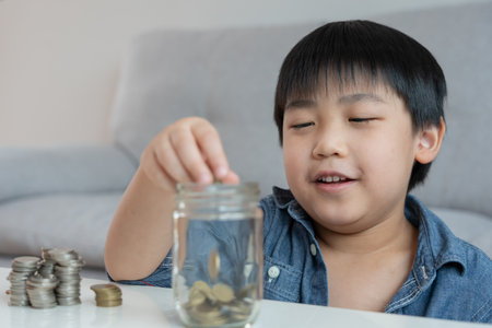 Save money. children putting coin for saving. wealth, Finance, insurance, investment, education, future, plan life, learn, banking, family, health, health and accident insurance.の写真素材