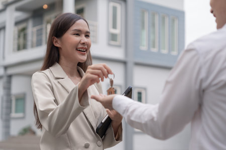 lease, rental and selling home. Real estate agent manager smile holding key for new owner.  rent house, Sales, loan credit financial, insurance, Seller, dealer, installment,  buy, sell, move inの写真素材