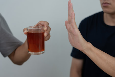 man refuses say no and avoid to drink an alcohol whiskey , stopping hand sign male, alcoholism treatment, alcohol addiction, quit booze, Stop Drinking Alcohol. Refuse Glass liquor, unhealthy, rejectの写真素材