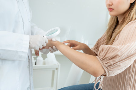 skin problem and beauty of asian girl. Dermatologist use magnifying glass look itchy skin from skin allergic, steroid allergy, sensitive skin, chemical allergy, rash, insect bites, Dermatitis.の写真素材