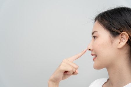 plastic surgery, beauty asian smile and happy after surgery, surgical procedure that involve altering shape of nose, doctor examines patient nose before rhinoplasty, medical assistance, healthの写真素材