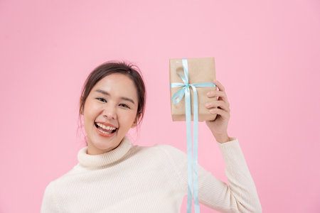 Pretty asian woman feel surprise and look interest receive presents box. cute girl excited gift box. birthday, Celebration, xmas, New year Festival, thank, Celebrate, Valentine Day, Anniversaryの写真素材