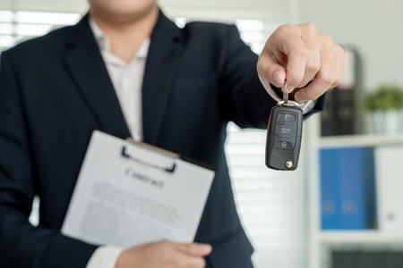 lease, rental car, sell, buy. Dealership manager send car keys to the new owner.  Sales, loan credit financial, rent vehicle, insurance,  renting, Seller, dealer, installment, car care businessの写真素材