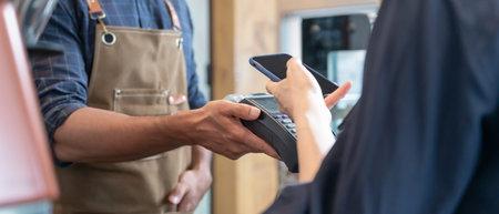 Woman use smartphone to scan QR code to pay in cafe restaurant with a digital payment without cash....