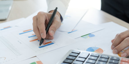 Business men calculate benefit, spreadsheets, graph financial development, bank accounts, statistics, economy, data analysis, investment analysis, stock exchange,Interest rates, incomeの写真素材