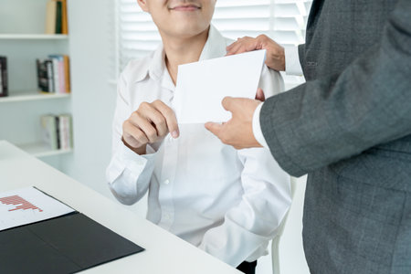 Businessmen receive salary or bonuses from management or Boss. Company give rewards to encourage work. Smiling businessman enjoying a reward at the desk in the officの写真素材