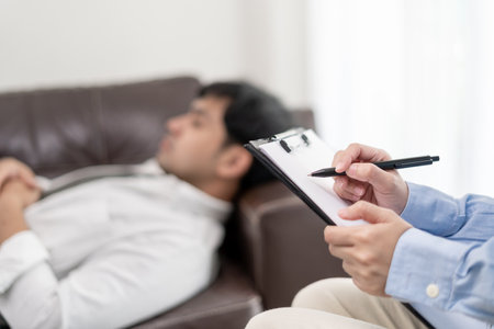 man with mental health problems is consulting. psychiatrist is recording the patient's condition for treatment. encouragement, love and family problem, bipolar , depression patient, protect suicideの写真素材
