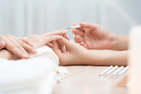 Woman receive care service by professional Beautician Manicure at spa centre. Nail beauty salon use nail file for Glazing treatment. manicurist make nail customer to beautiful. body care spa treatmentの写真素材