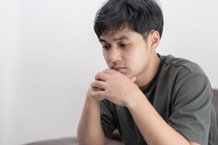 Depression and mental illness. Asian man disappoint, sad after receive bad news. Stressed boy confused with unhappy problem, arguing with girlfriend, cry and worry about unexpected work, down economy.の写真素材
