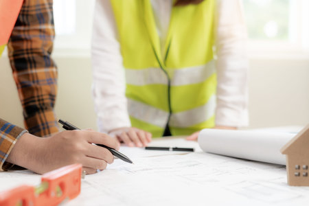 Engineers team discuss check and review the blueprint of construction. Contractor inspection drawing...