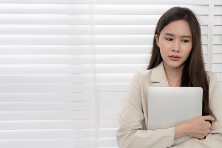 Depression and mental illness. Asian woman disappointed, sad after receiving bad news. Stressed girl confused with unhappy problems, arguing with boyfriend, cry and worry about unexpected pregnancy.の写真素材