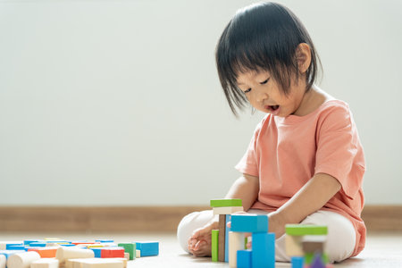 Happy Asian child playing and learning toy blocks. children are very happy and excited at home. child have a great time playing, activities, development, attention deficit hyperactivity disorderの写真素材