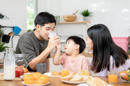 family time, breakfast, activities together during the holidays. Parents and children are having a meal together during the holidays. New home for family on morning, enjoy, weekend, vacant timeの写真素材