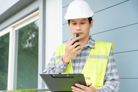 inspector or engineer is inspecting construction and quality assurance new house using a checklist....