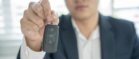 lease, rental car, sell, buy. Dealership manager send car keys to the new owner.  Sales, loan credit financial, rent vehicle, insurance,  renting, Seller, dealer, installment, car care businessの写真素材