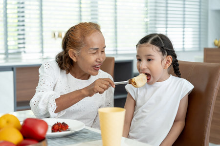 family time, breakfast, activities together during the holidays. Parents and children are having a meal together during the holidays. New home for family on morning, enjoy, weekend, vacant timeの写真素材